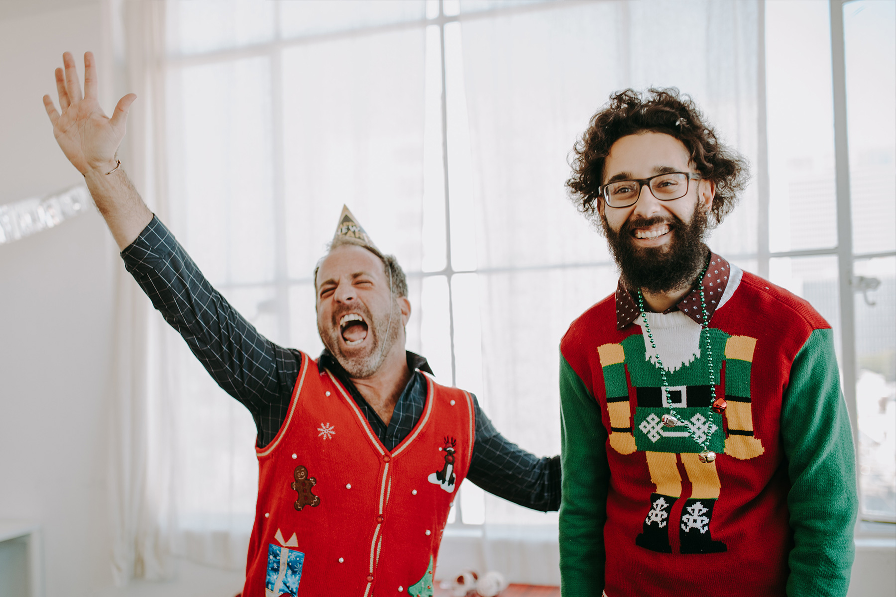 2 men in ugly Christmas sweaters